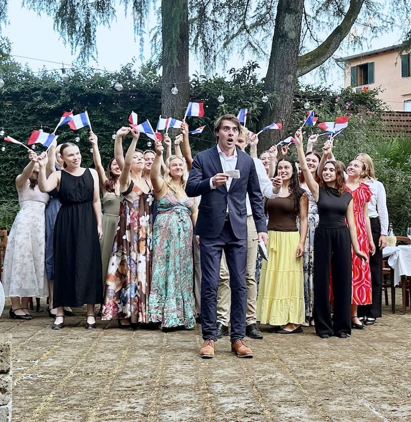 Group of people waving flags.